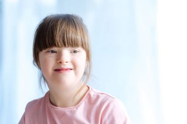 Portrait of cute kid with down syndrome clipart