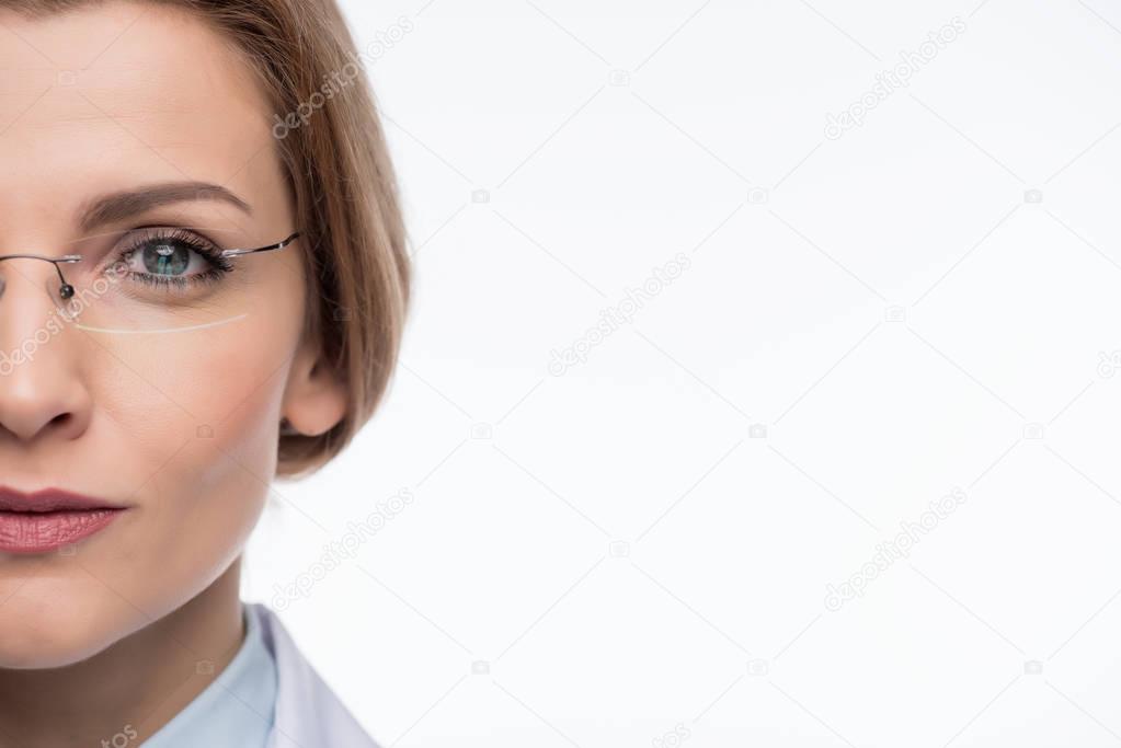 Close-up view of female doctor wearing glasses isolated on white