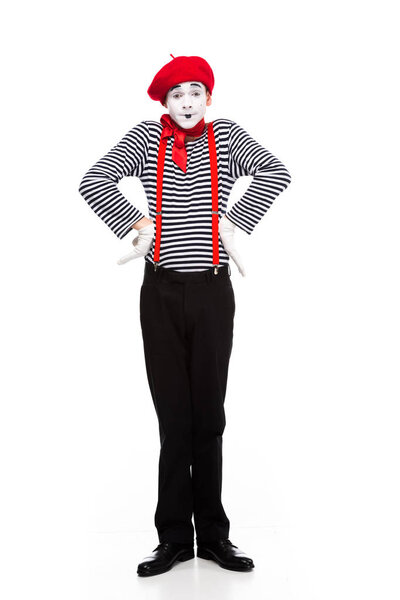 funny mime standing with hands akimbo isolated on white