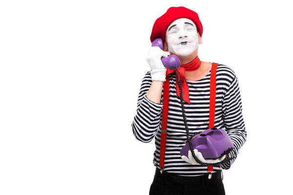 happy mime talking by retro stationary telephone with closed eyes isolated on white