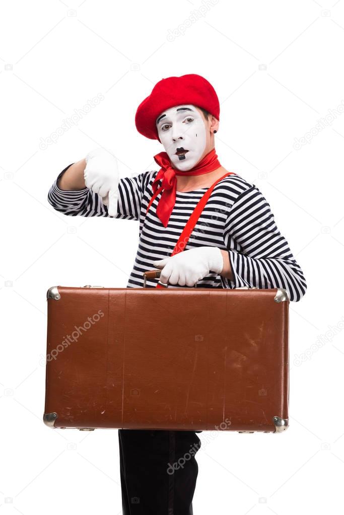 mime pointing on brown suitcase isolated on white