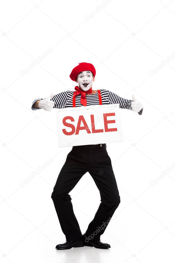 happy mime holding sale signboard and showing thumbs up isolated on white
