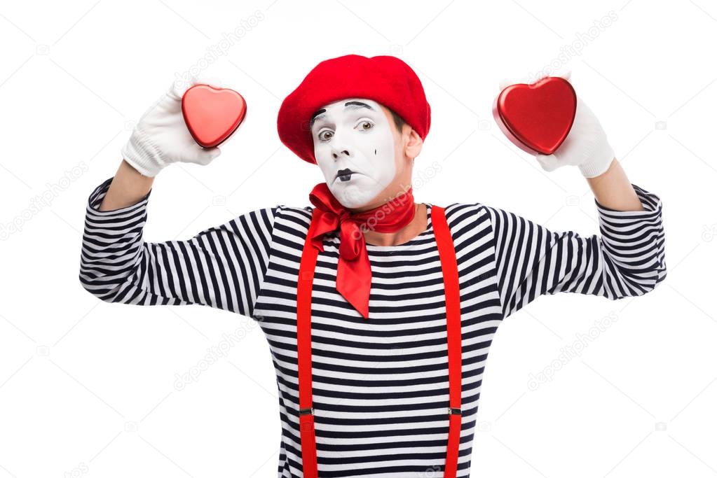 sad mime holding heart shaped gift boxes isolated on white, st valentines day concept