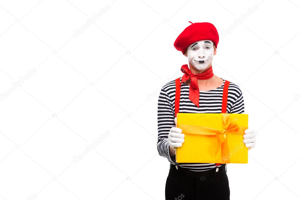 grimacing mime showing gift box isolated on white