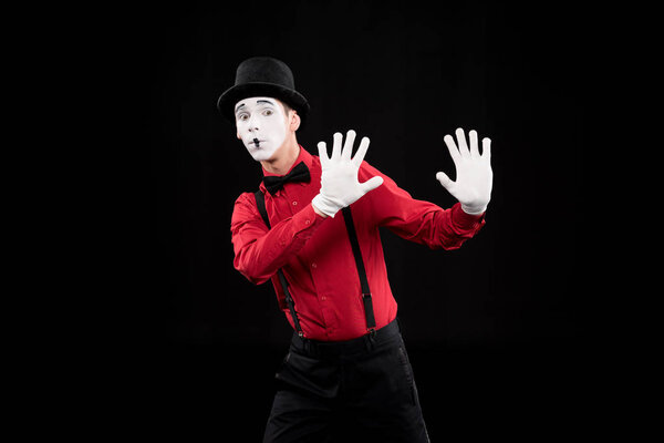 mime showing stop sign isolated on black