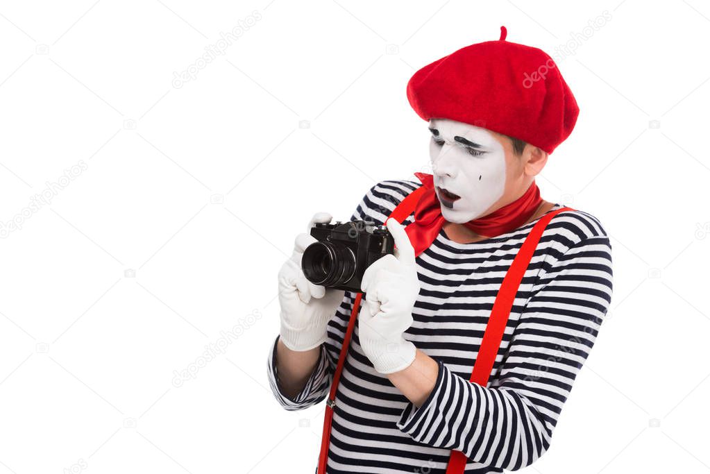 shocked mime taking photo with film camera isolated on white