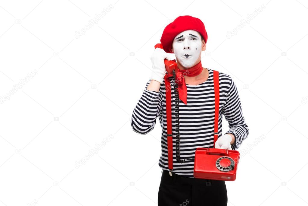 mime talking by stationary telephone isolated on white