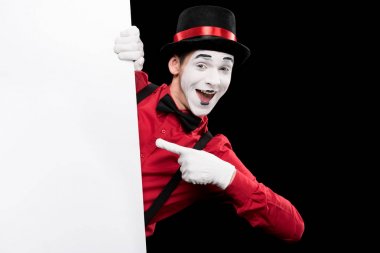 mime pointing on empty board isolated on black clipart
