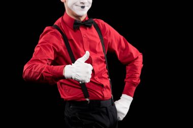 cropped image of mime showing thumb up isolated on black