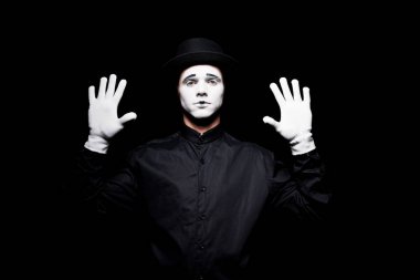 mime pretending touching something with hands isolated on black clipart