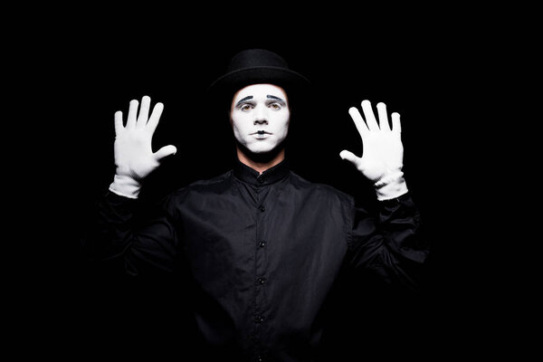 mime pretending touching something with hands isolated on black