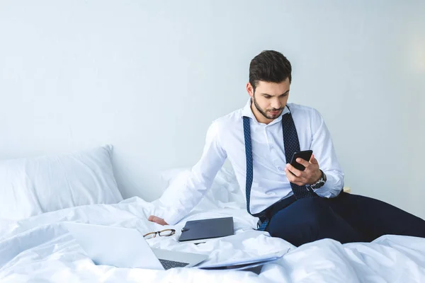 Businessman Working Smartphone Documents Laptop Bed Morning — Stock Photo, Image