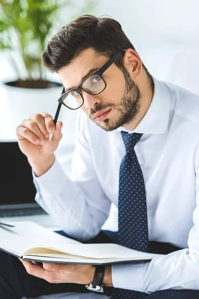 Handsome Thoughtful Businessman Eyeglasses Sitting Bed Diary — Stock Photo, Image