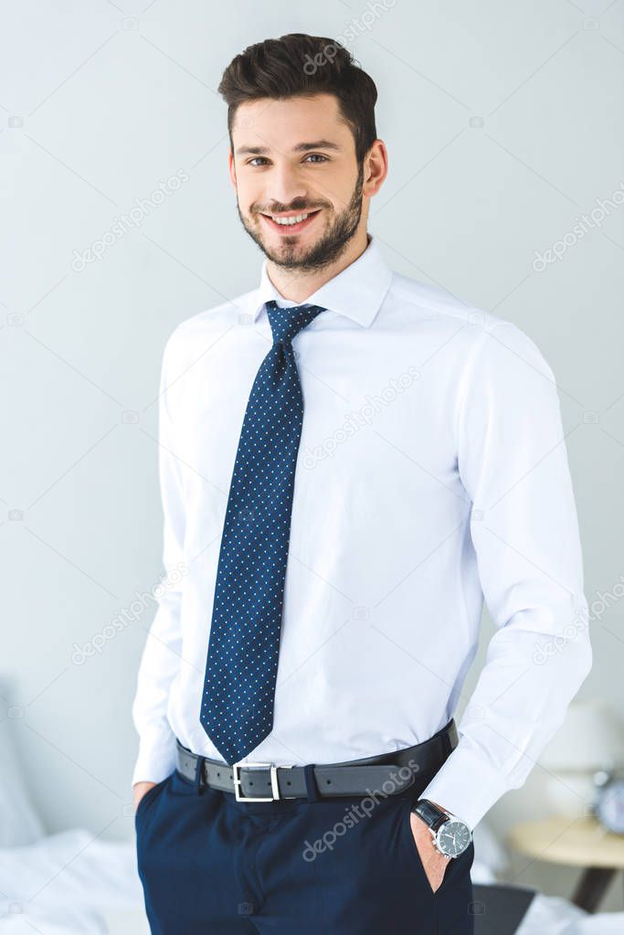 handsome smiling businessman in white shirt and tie 
