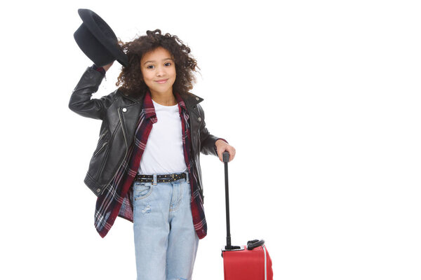 happy little child in stylish clothing and hat with luggage isolated on white