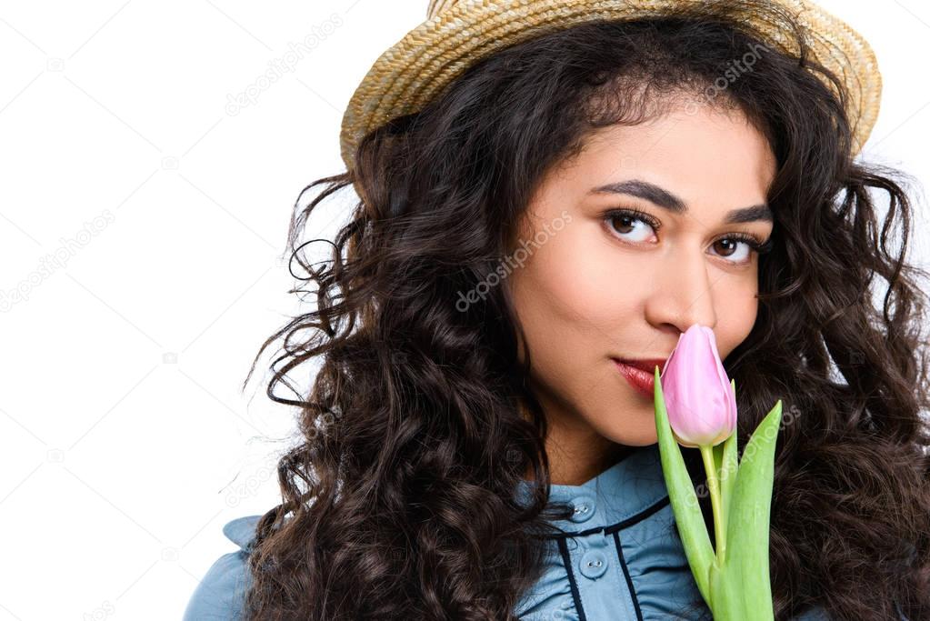 beautiful young woman with tulip flower isolated on white