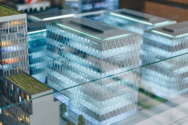 Miniature model of modern city under glass