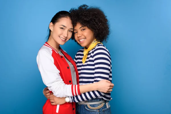 Happy African American Asian Friends Hugging Isolated Blue — Foto Stok Gratis