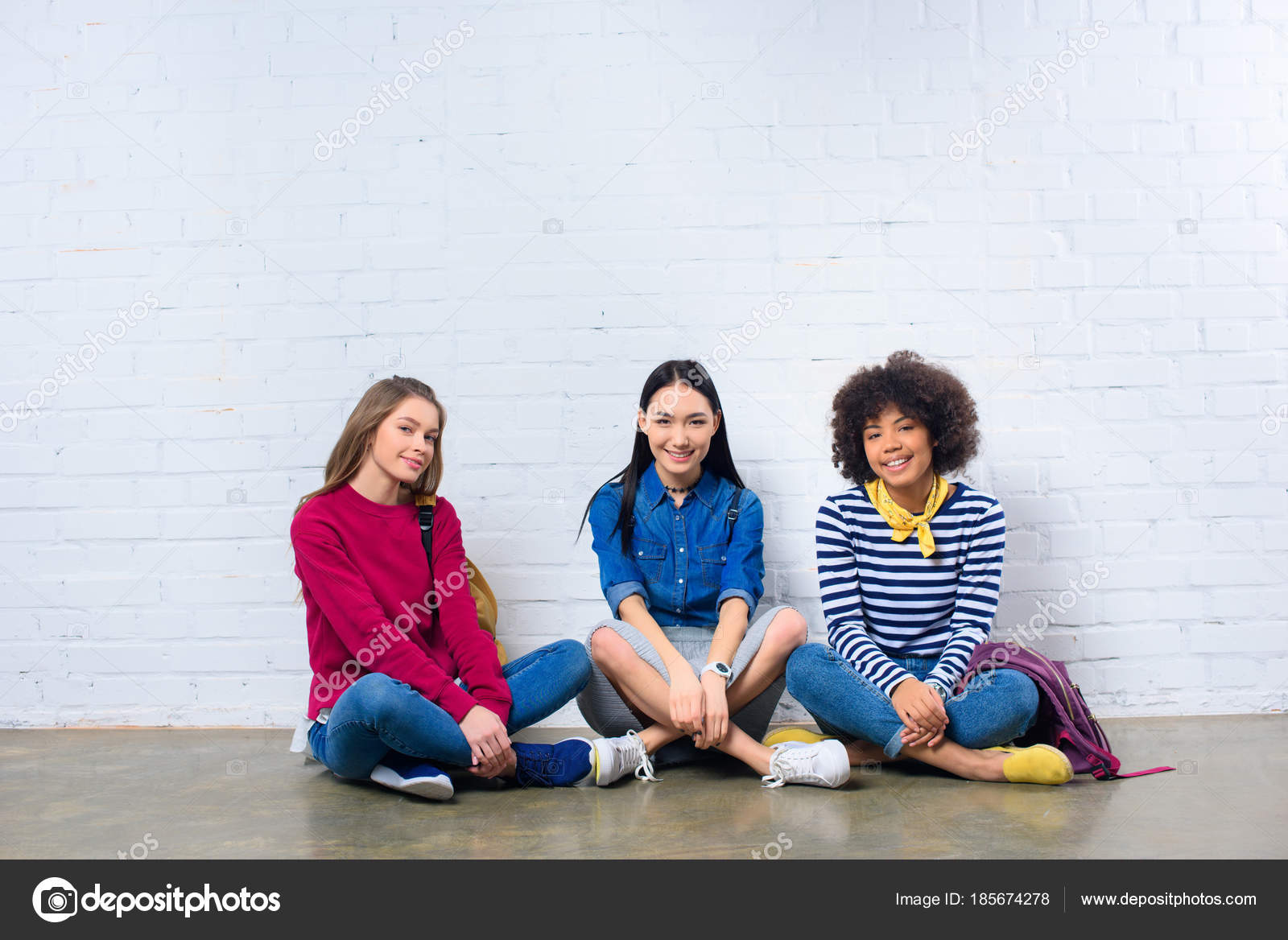 Group Multiracial Students Sitting Floor White Brick Wall Stock