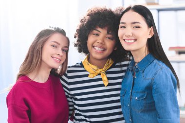 portrait of cheerful multiracial students looking at camera clipart