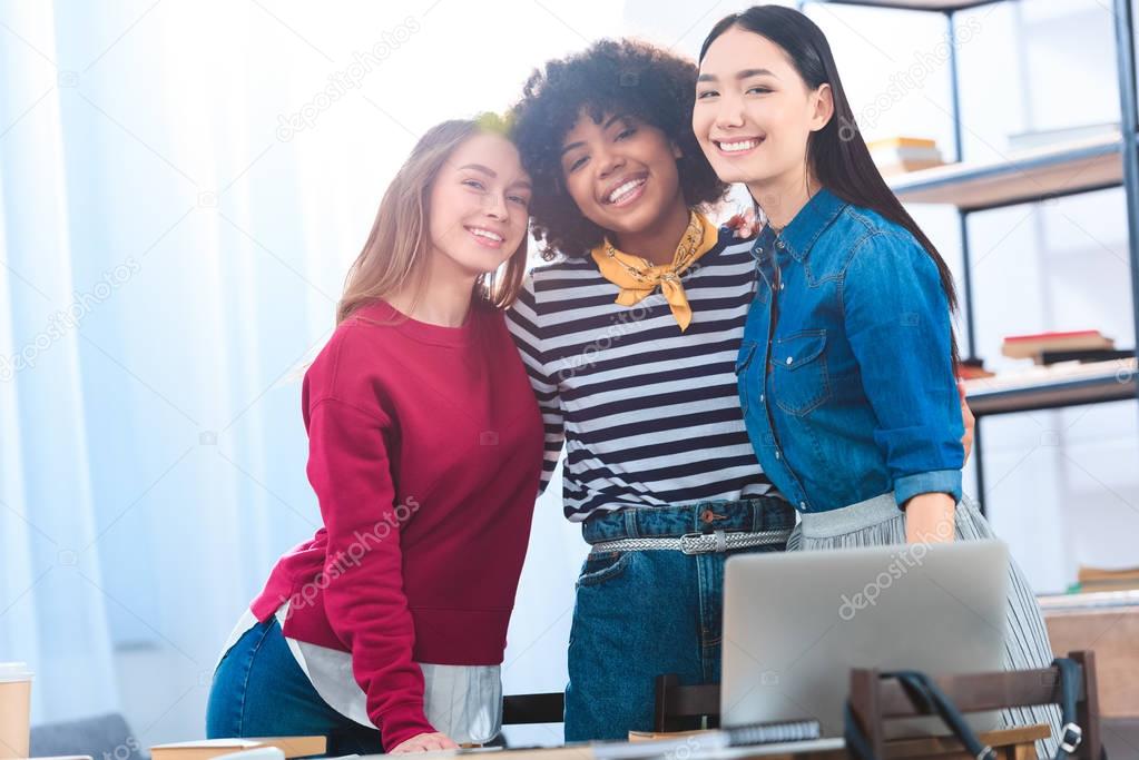 portrait of pretty multiracial students looking at camera