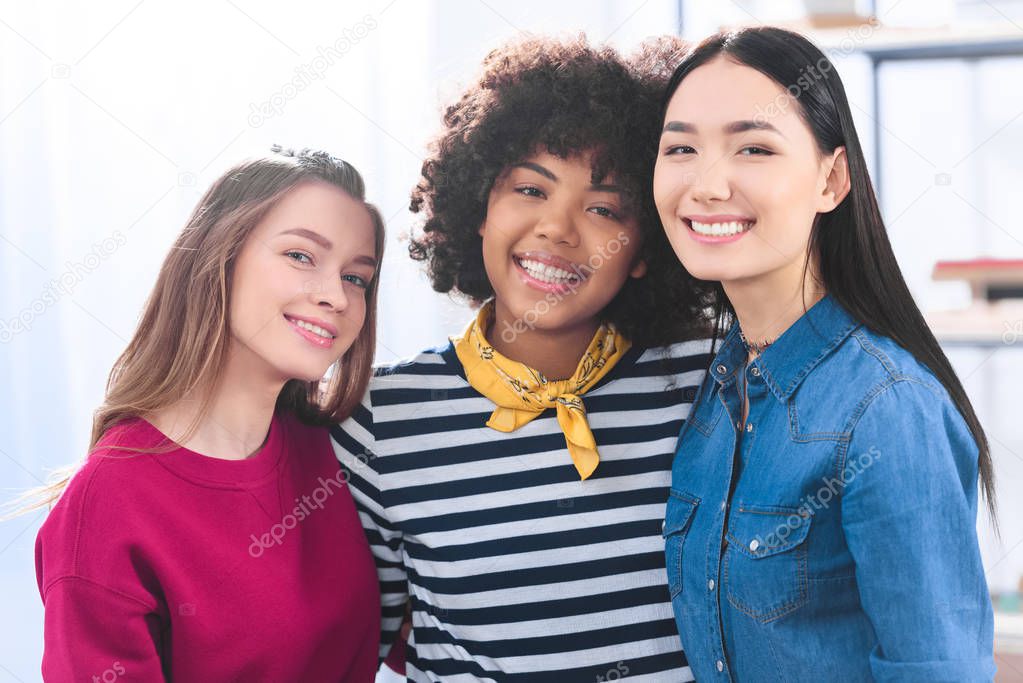 portrait of cheerful multiracial students looking at camera