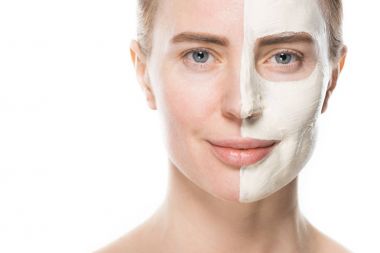 Portrait of woman with facial skincare mask isolated on white clipart