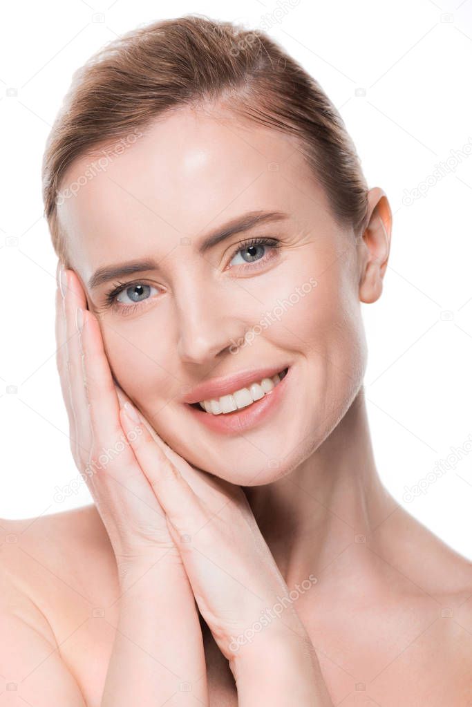 Portrait of female with clean skin touching own face isolated on white