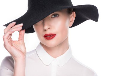 Woman with hidden eye under hat isolated on white