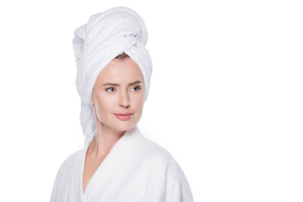 Woman with clean skin in bathrobe and towel on hair isolated on white