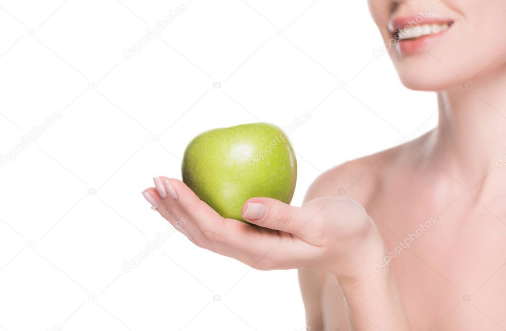 Cropped view of woman with clean skin holding apple isolated on white