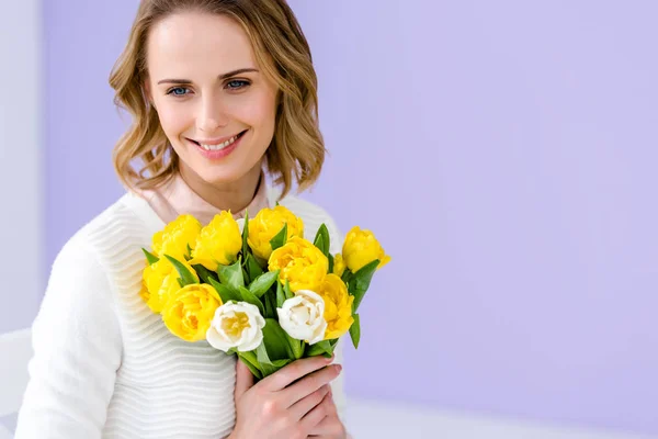 Attractive young woman holding tulips for women\'s day