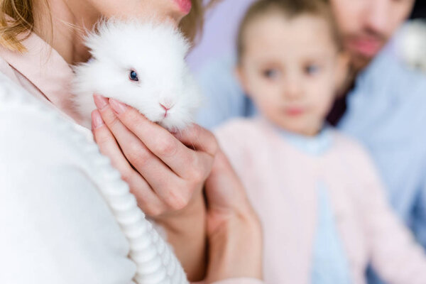 Mother with family holding cute bunny 