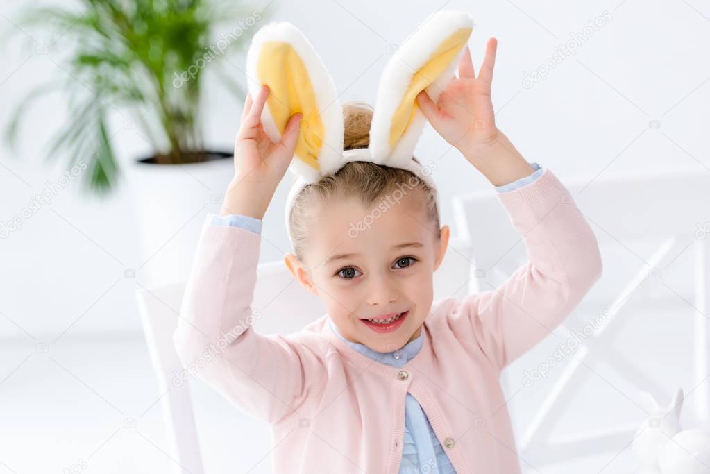 Cute child girl playing with bunny ears