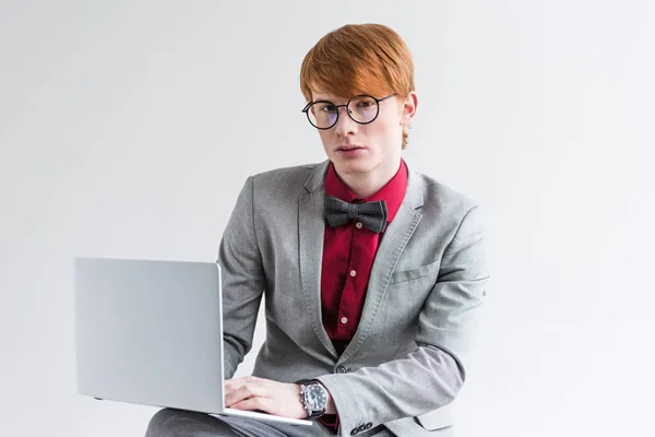 Young Male Fashion Model Eyeglasses Using Laptop Isolated Grey — Stock Photo, Image