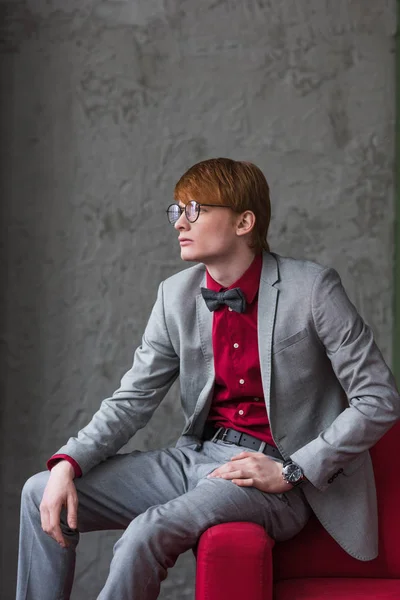Profile Male Model Eyeglasses Dressed Suit Sitting Edge Couch — Stock Photo, Image