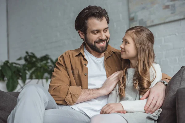 Smiling Father Hugging Daughter Sofa Home — Free Stock Photo