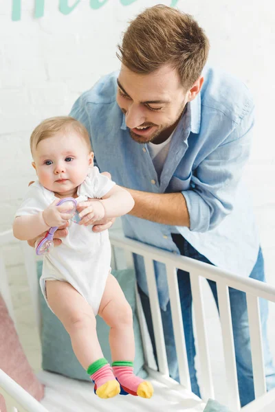 Happy Father Holding Infant Daughter Toy Crib — Stock Photo, Image