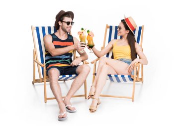 couple relaxing and clinking glasses with summer cocktails, isolated on white