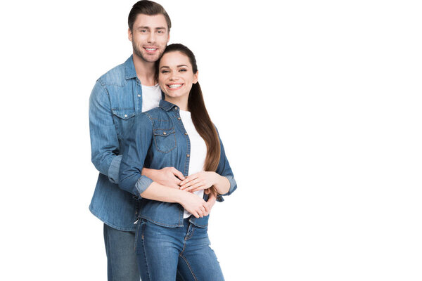 young embracing couple looking at camera, isolated on white