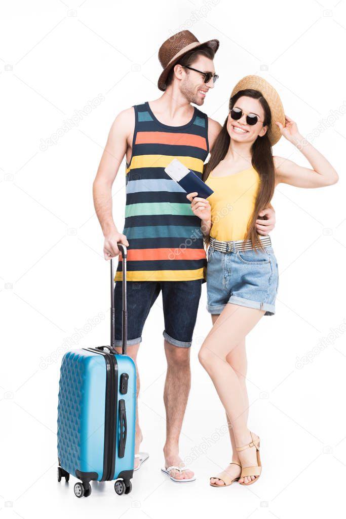 happy tourists with travel bag, isolated on white 