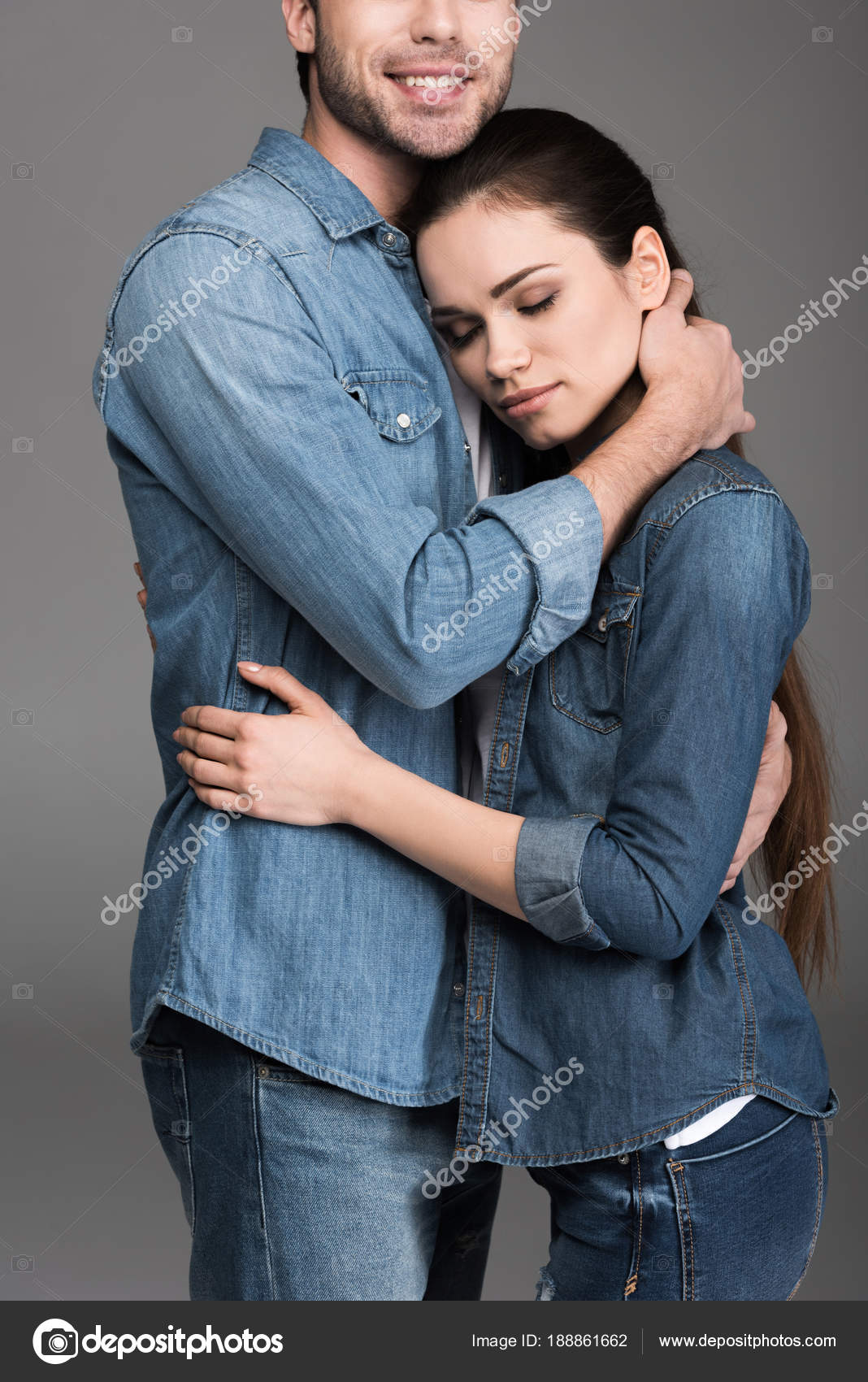 Young Couple Denim Clothes Embracing Isolated Grey Stock Photo by