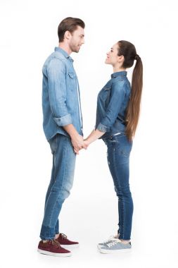 young couple holding hands and looking at each other, isolated on white