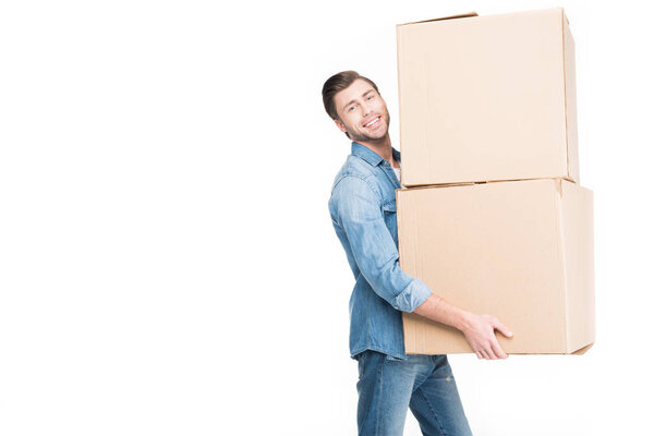 happy young man relocating with cardboard boxes, isolated on white