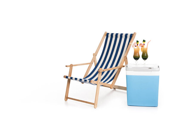 striped beach chair, cooler box and summer cocktails, isolated on white