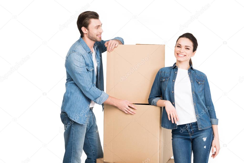 moving couple with carton boxes, isolated on white
