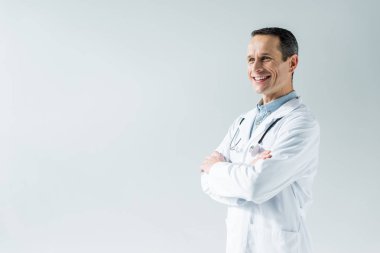 çapraz kolları üzerinde beyaz izole olan yakışıklı yetişkin doktor