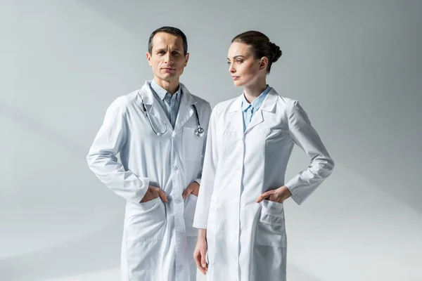 Confident Adult Doctors White Coats Grey — Stock Photo, Image