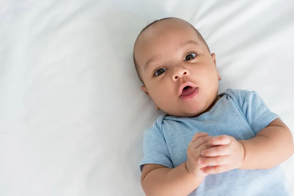 Infant Little Baby Surprised Expression Looking Camera While Lying Bed — Stock Photo, Image