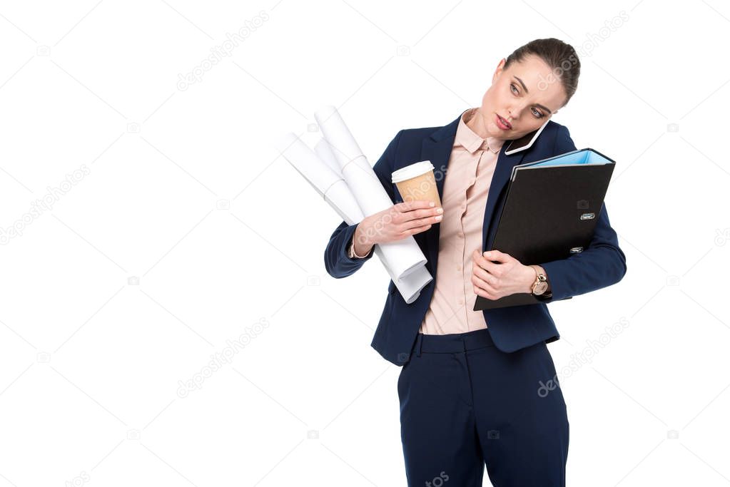 adult businesswoman with lot of paperwork and coffee to go talking by phone isolated on white